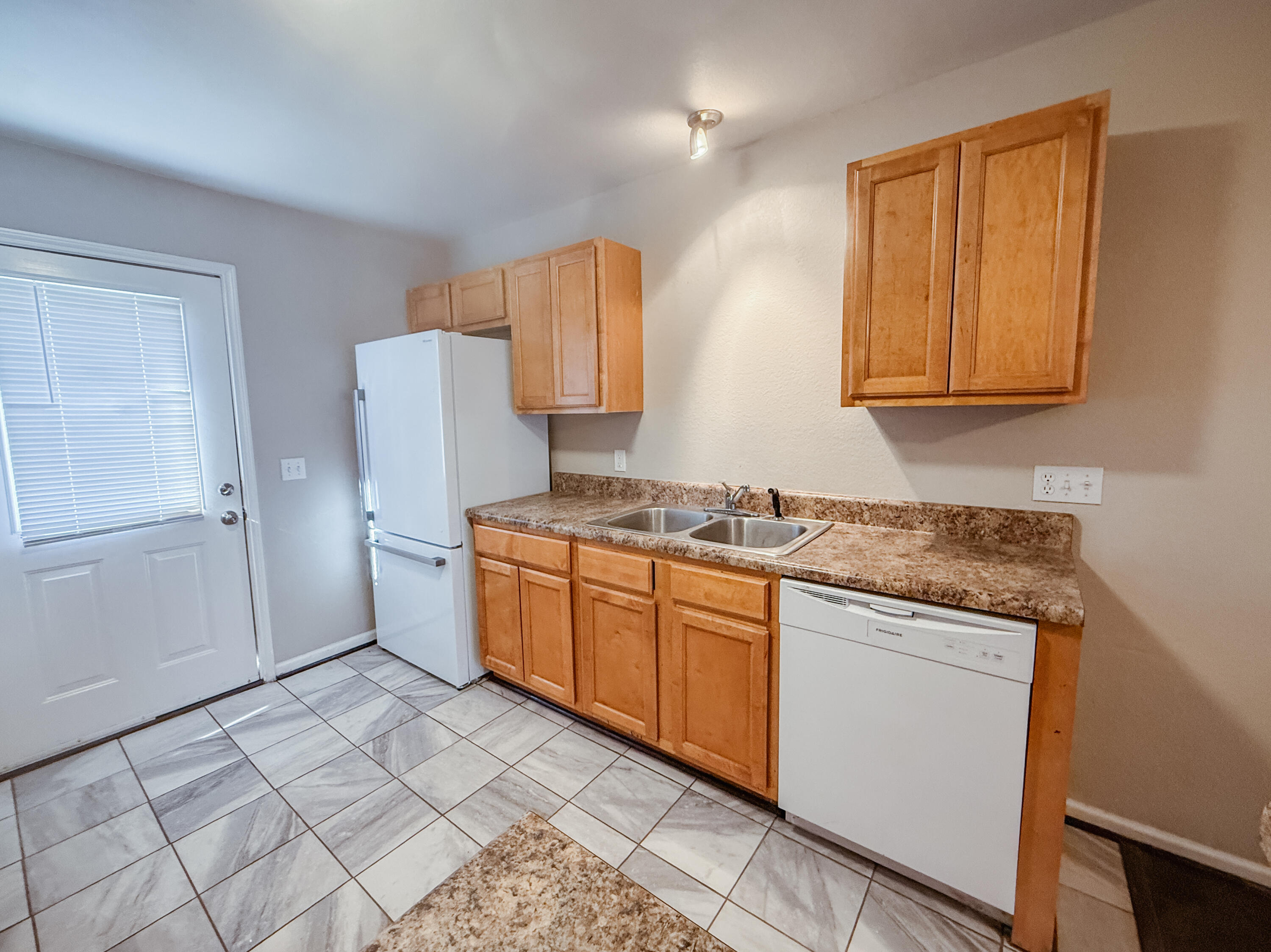 1150 Airport Road, Unit 110 Destin, FL 32541 - Photo 6 of 20 a kitchen with granite countertop a sink cabinets and stainless steel appliances