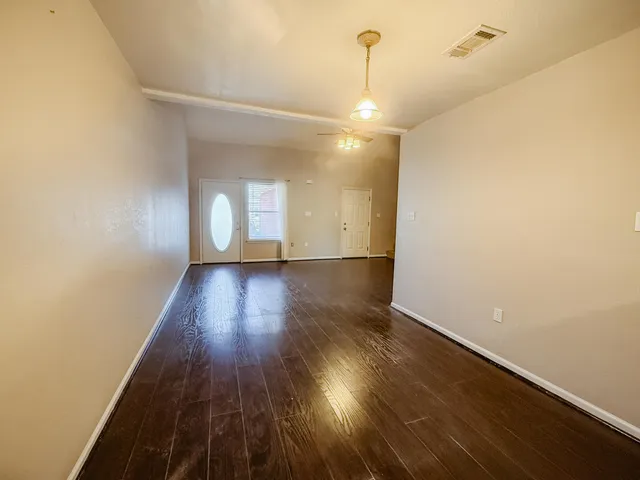 a view of a room with wooden floor and window