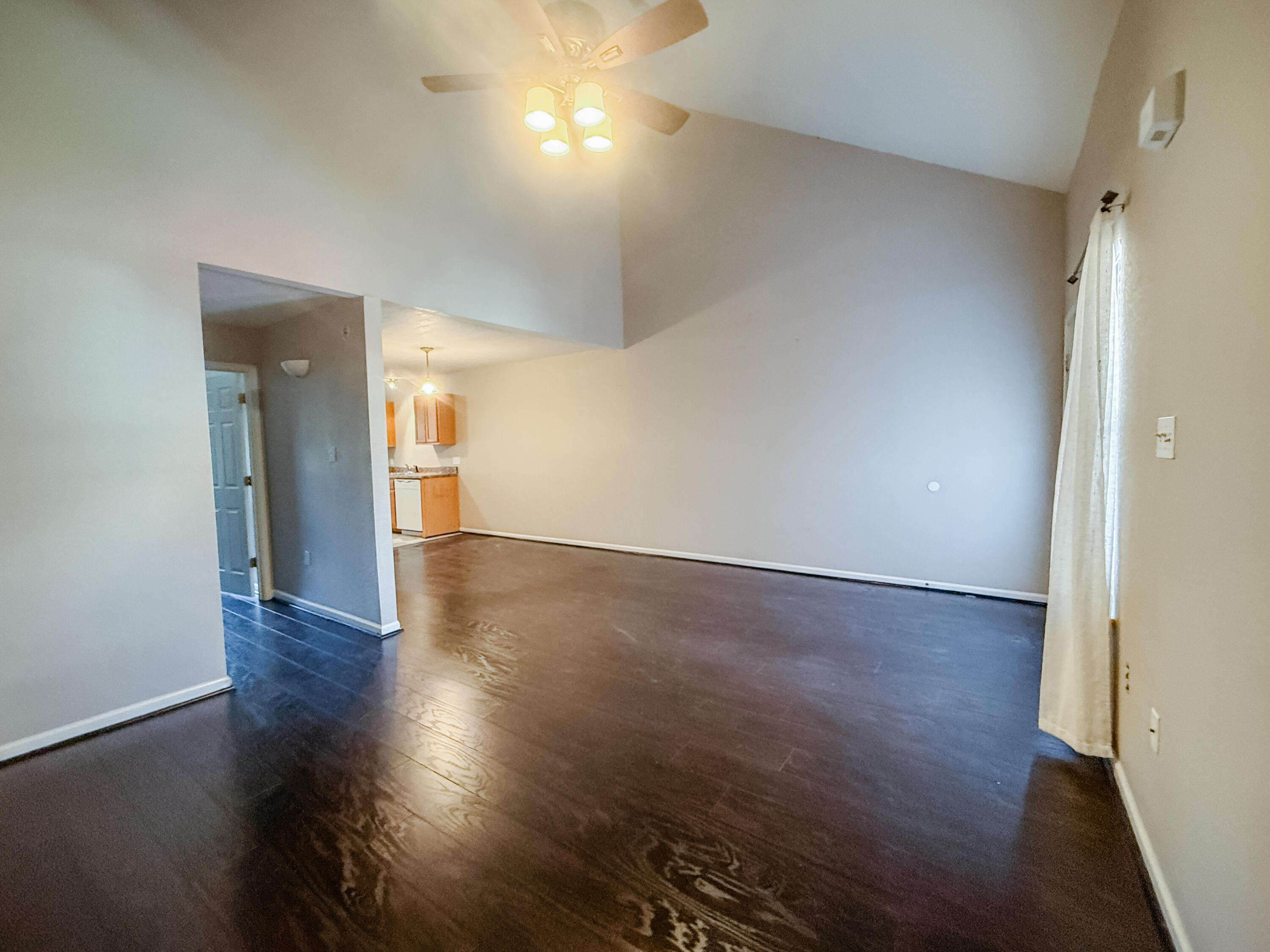 1150 Airport Road, Unit 110 Destin, FL 32541 - Photo 9 of 20 an empty room with wooden floor and windows