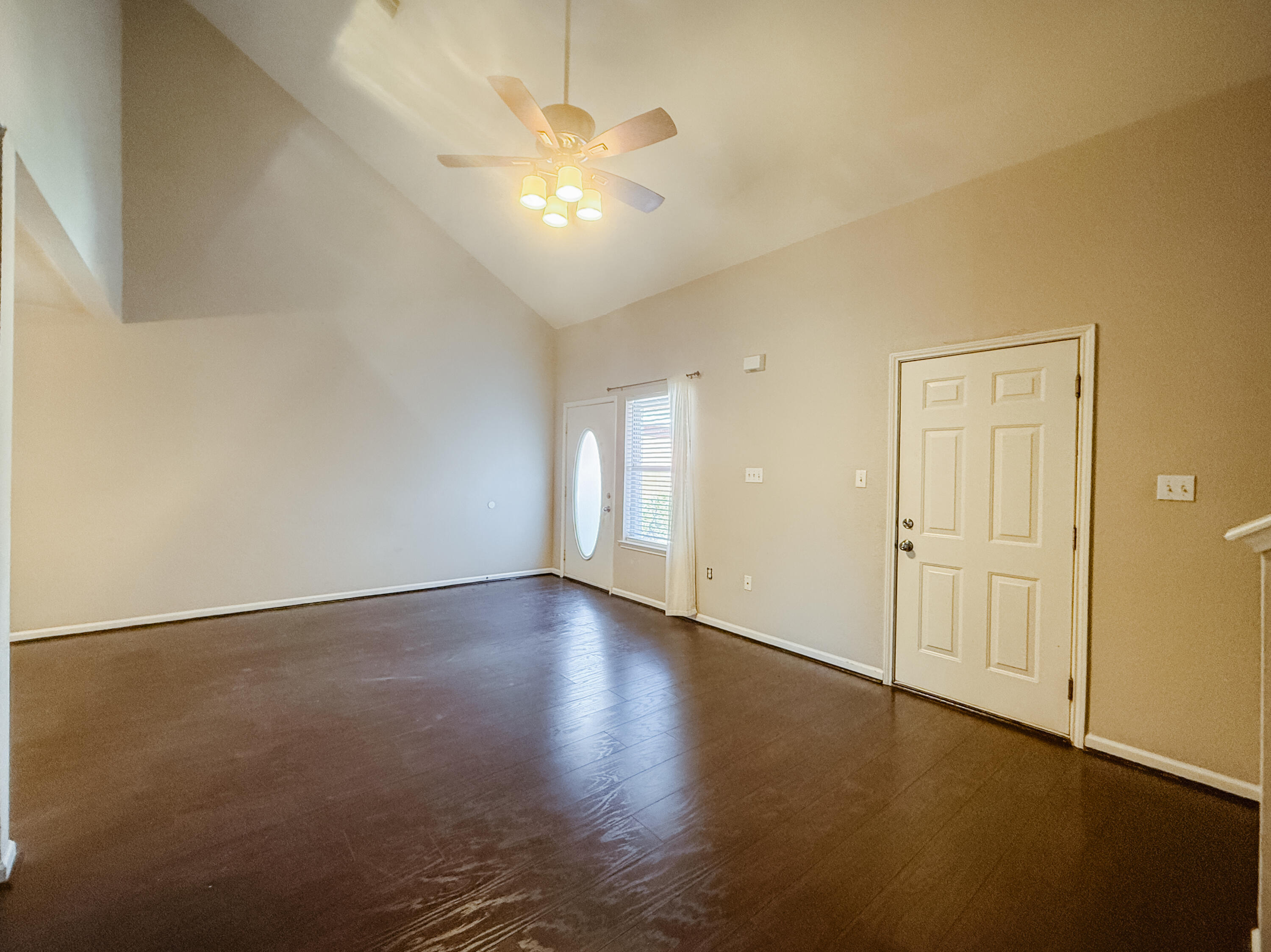 1150 Airport Road, Unit 110 Destin, FL 32541 - Photo 10 of 20 an empty room with wooden floor and windows