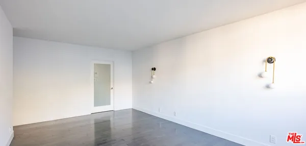 a view of a room with wooden floor