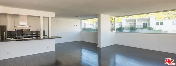 a view of a room with wooden floor and a window