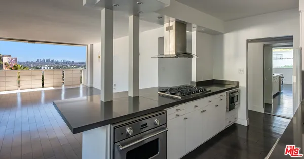 a kitchen with granite countertop a stove and a refrigerator