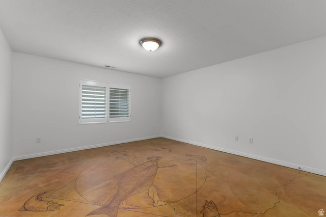439 East 13540 South Draper, UT 84020 - Photo 34 of 46 Spacious room featuring a unique patterned floor, white walls, and a window with plantation shutters