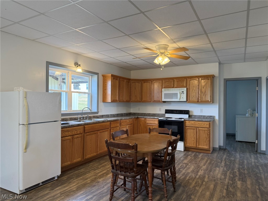23033 Cadiz Road Freeport, OH 43973 - Photo 5 of 31 Kitchen featuring white appliances, wood finish cabinets, washer / dryer, dark wood-style flooring, and a drop ceiling