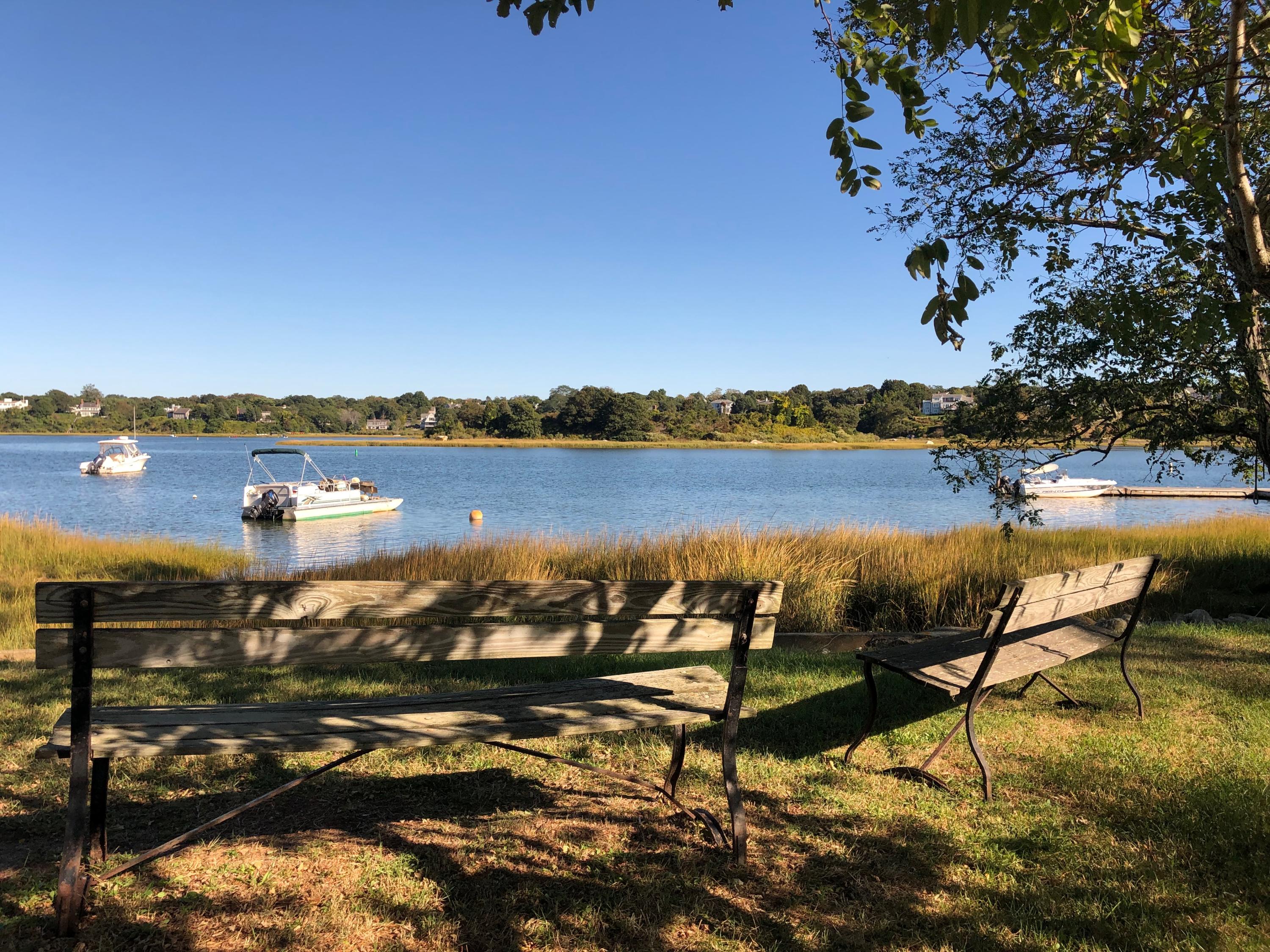 a view of a lake with table and chairs