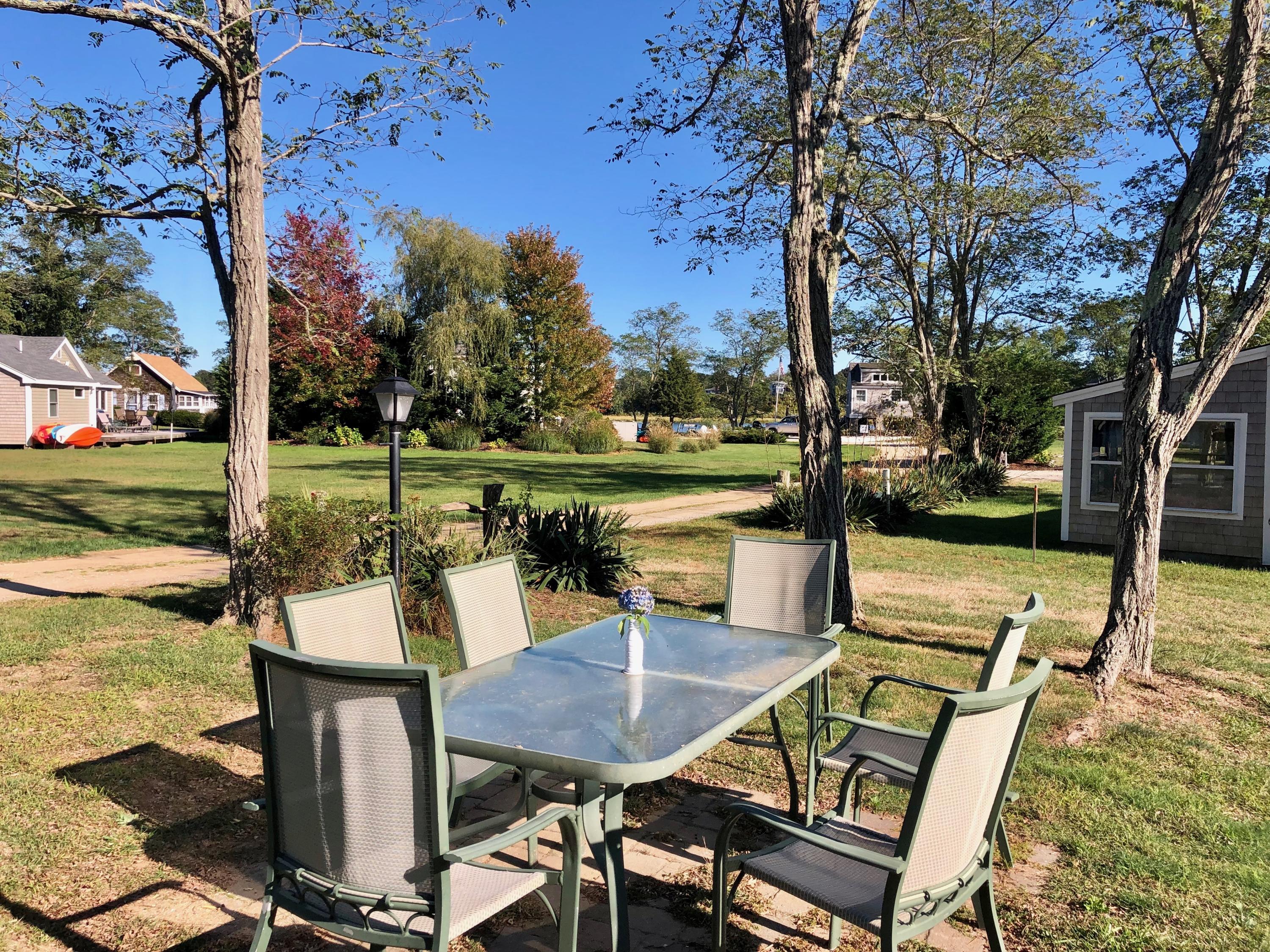 710 State Highway Eastham, MA 02642 - Photo 14 of 17 a view of a swimming pool with a table and chairs
