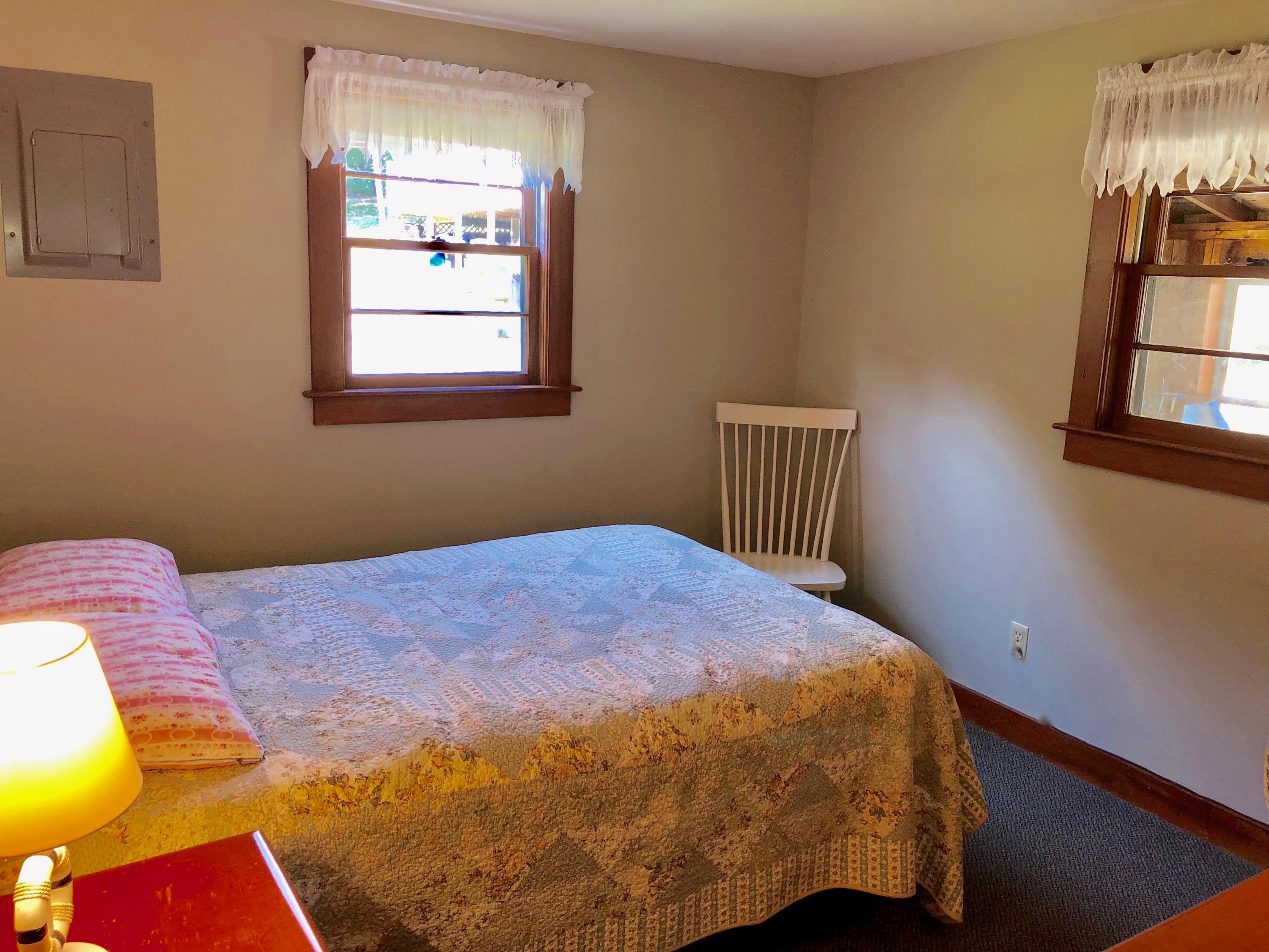 710 State Highway Eastham, MA 02642 - Photo 10 of 17 a bedroom with a bed and wooden floor