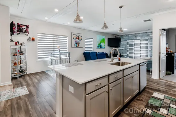 a kitchen with stainless steel appliances kitchen island a large island in the center
