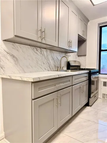 a kitchen with granite countertop white cabinets and white appliances