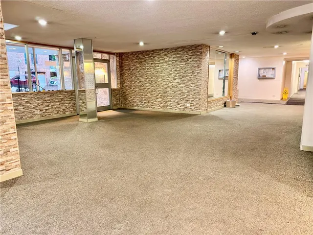 an empty room with a empty space and windows