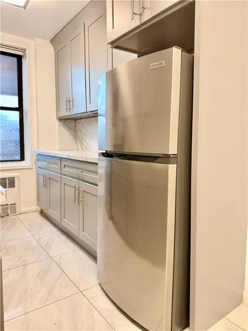 a white refrigerator freezer sitting in a kitchen