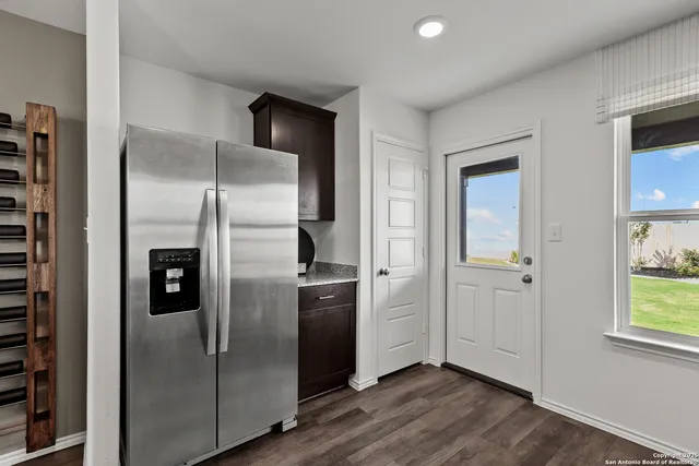 a kitchen with stainless steel appliances granite countertop a refrigerator and a sink
