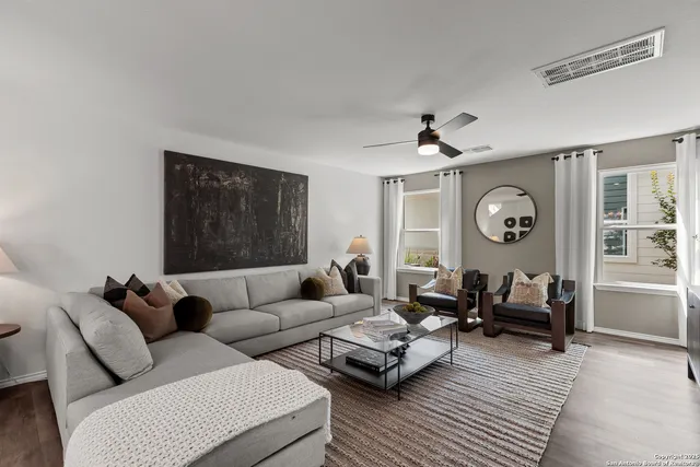 a living room with furniture and a large window