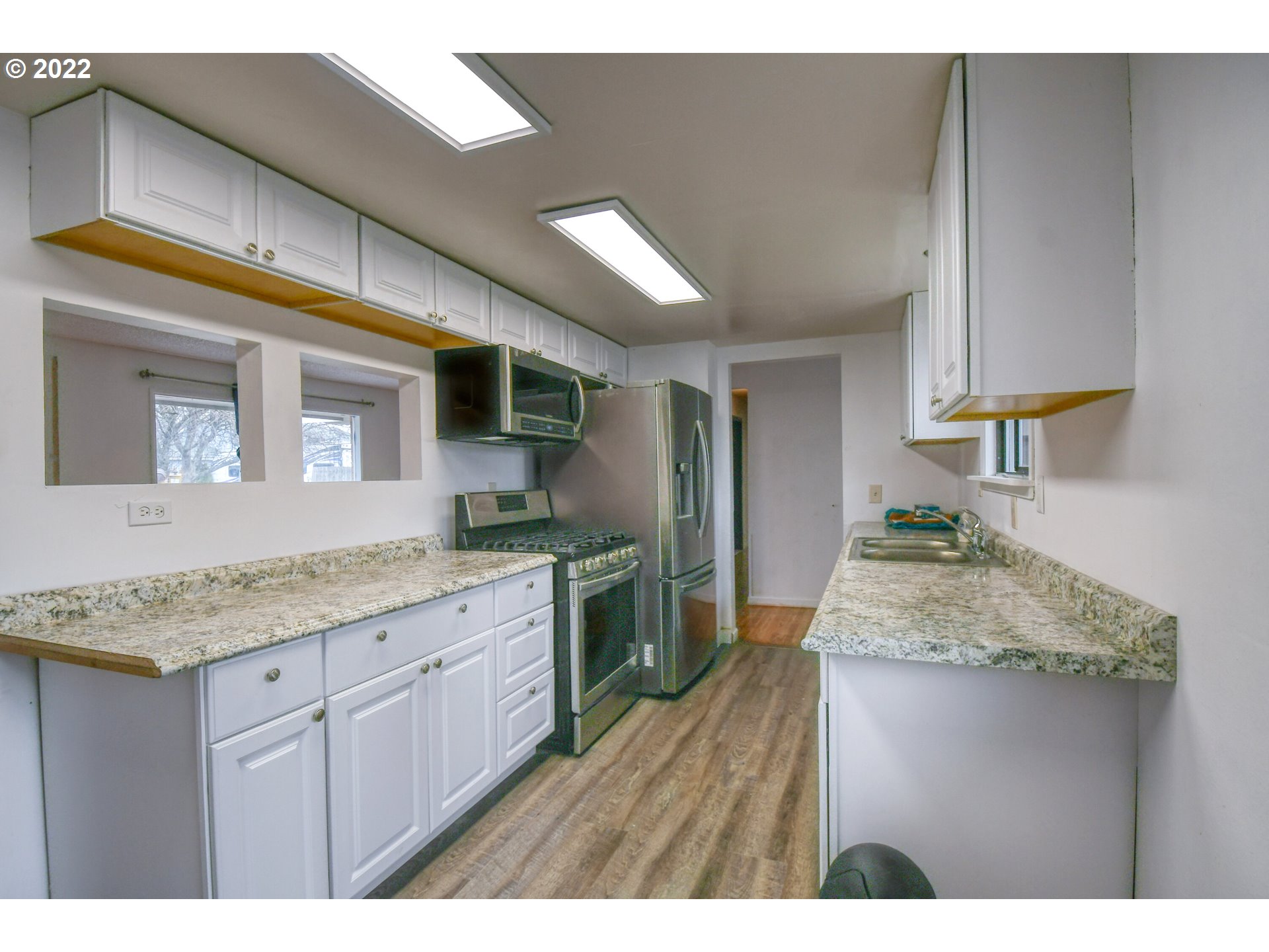 1410 Southwest 41st Street Pendleton, OR 97801 - Photo 11 of 32 a kitchen with granite countertop a sink stainless steel appliances and cabinets