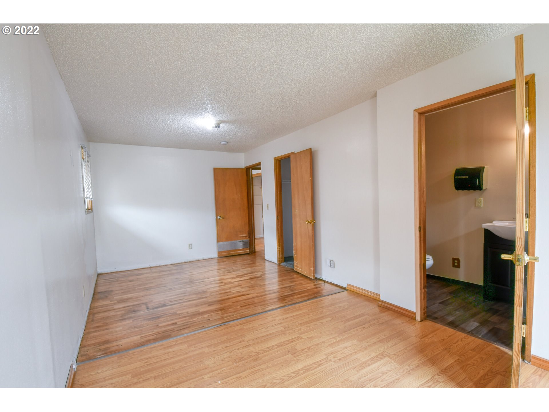 1410 Southwest 41st Street Pendleton, OR 97801 - Photo 12 of 32 a view of an empty room with wooden floor and a window