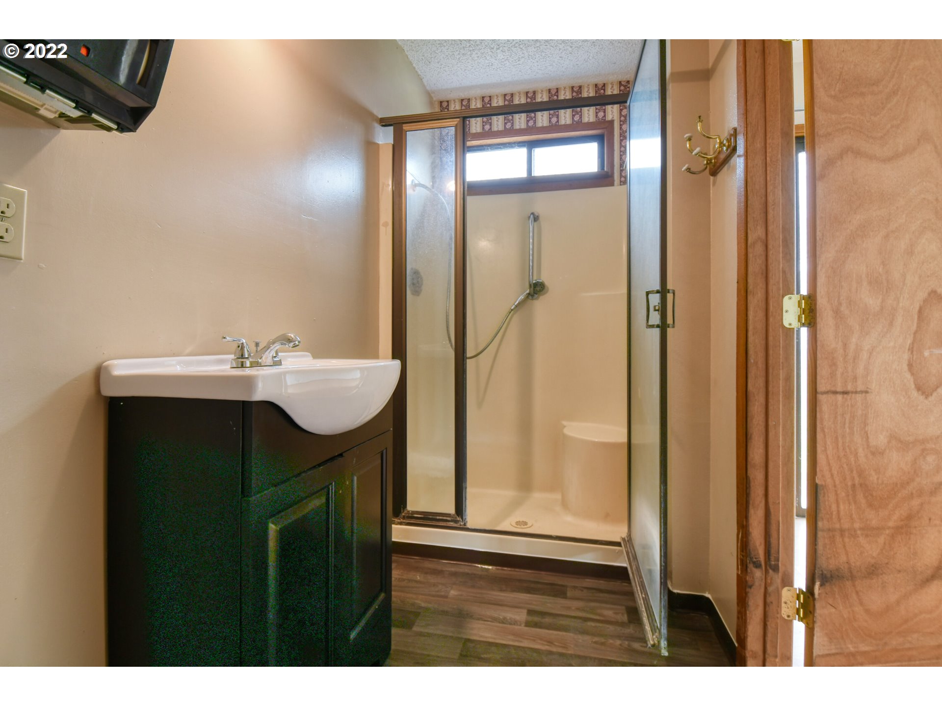 1410 Southwest 41st Street Pendleton, OR 97801 - Photo 13 of 32 a bathroom with a sink a mirror and a shower