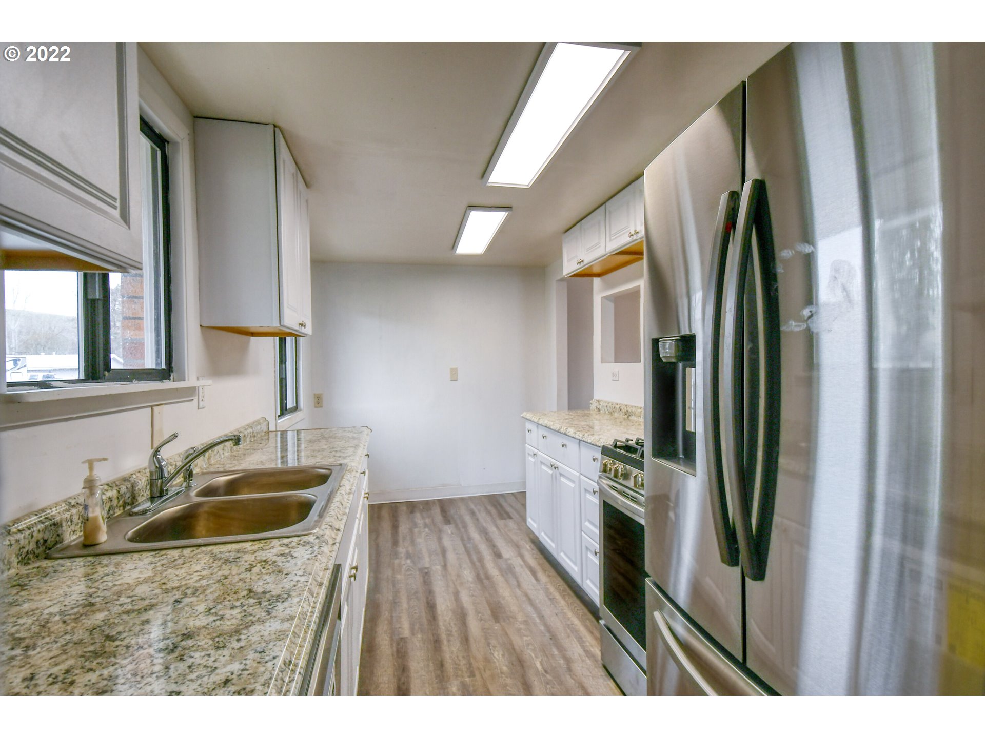 1410 Southwest 41st Street Pendleton, OR 97801 - Photo 8 of 32 a kitchen view with a sink a refrigerator and wooden floor