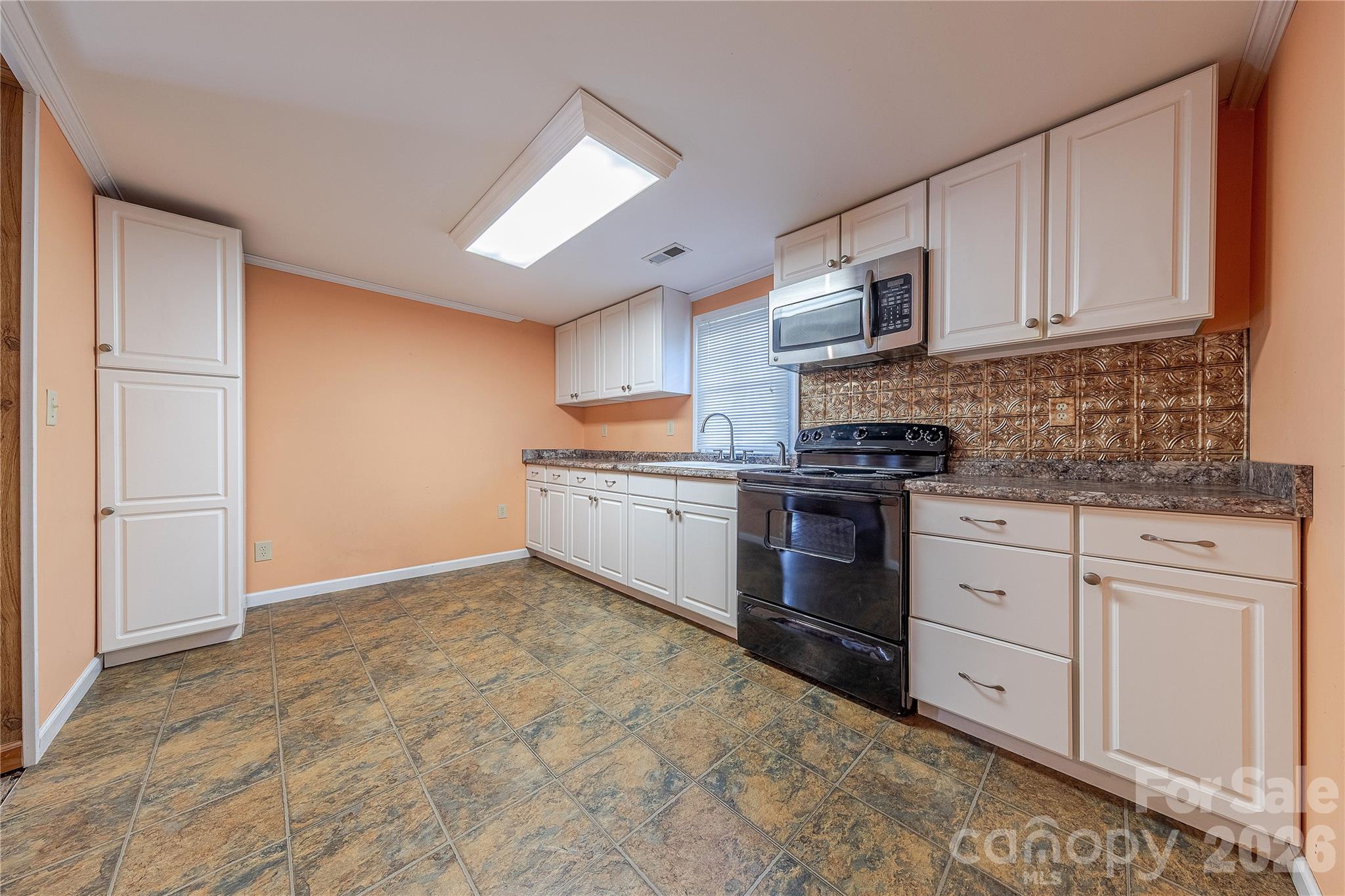 107 Valley Avenue Clover, SC 29710 - Photo 4 of 17 a kitchen with granite countertop white cabinets stainless steel appliances and sink