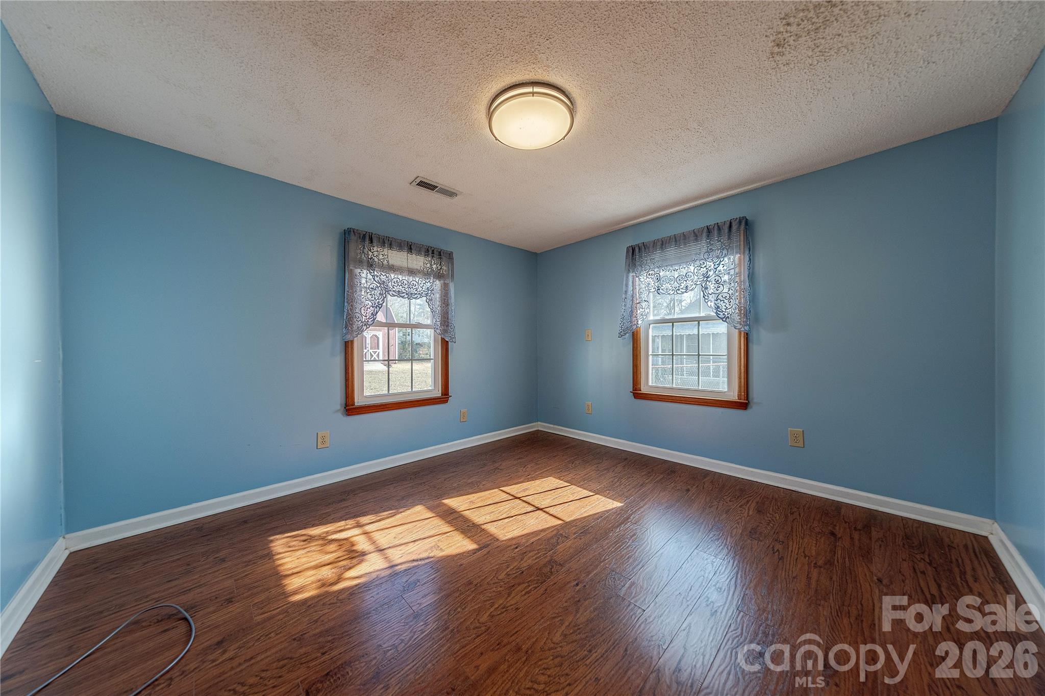 107 Valley Avenue Clover, SC 29710 - Photo 8 of 17 a view of empty room with wooden floor and fan