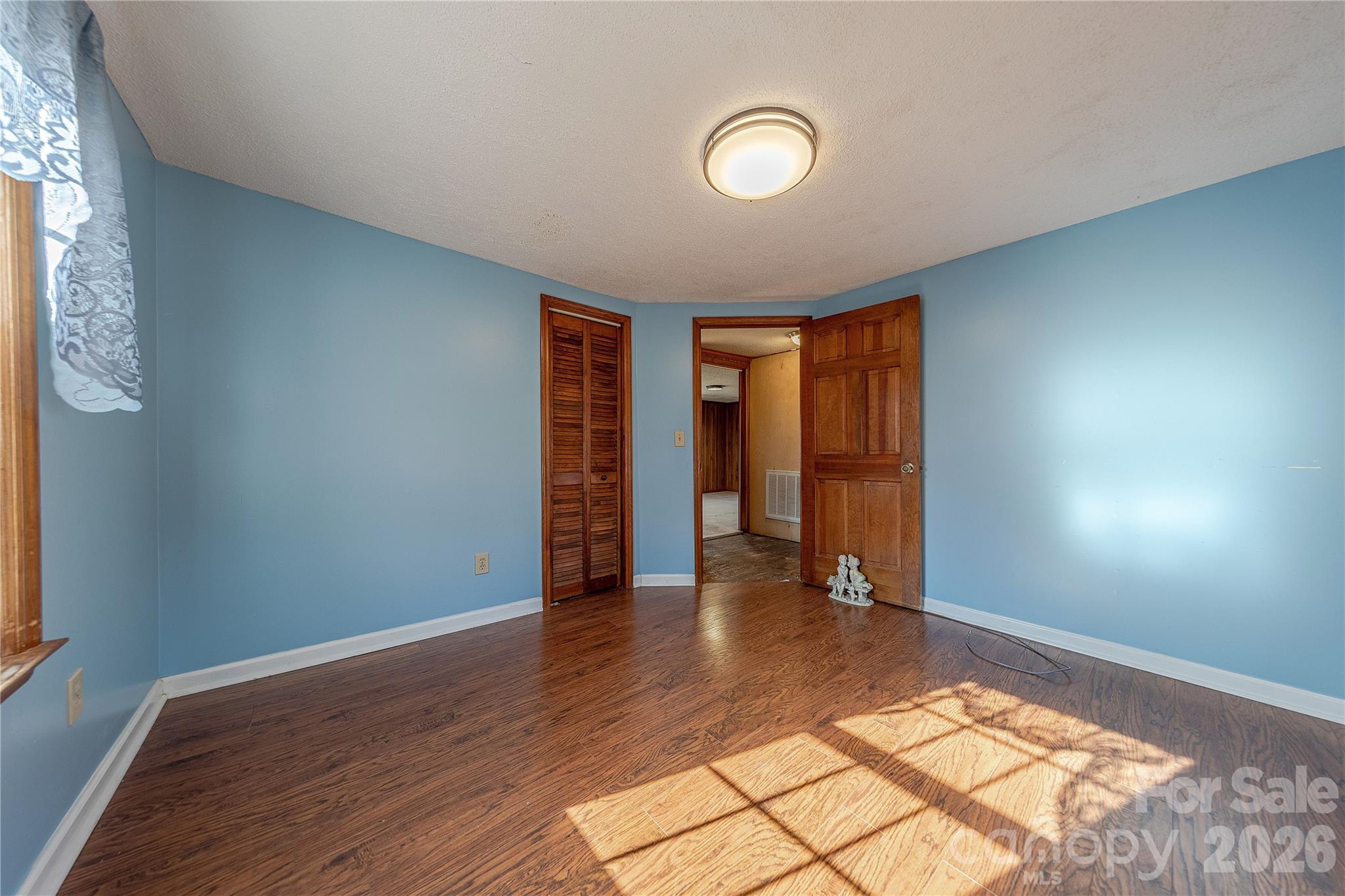 107 Valley Avenue Clover, SC 29710 - Photo 9 of 17 an empty room with wooden floor and windows