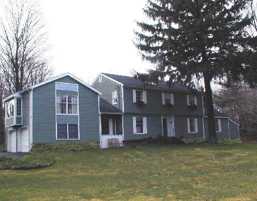 46 Flat Swamp Road Newtown, CT 06470 - Photo 1 of 1 a front view of a house with a garden