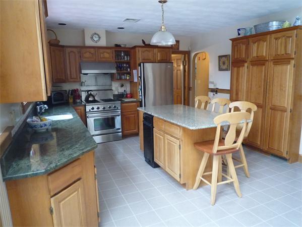 6 Stanley Road Middleton, MA 01949 - Photo 6 of 24 a kitchen with stainless steel appliances granite countertop a stove refrigerator and a sink