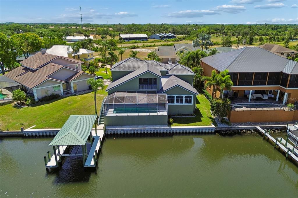 703 Bunker View Drive Apollo Beach, FL 33572 - Photo 45 of 49 an aerial view of a house with swimming pool and a yard