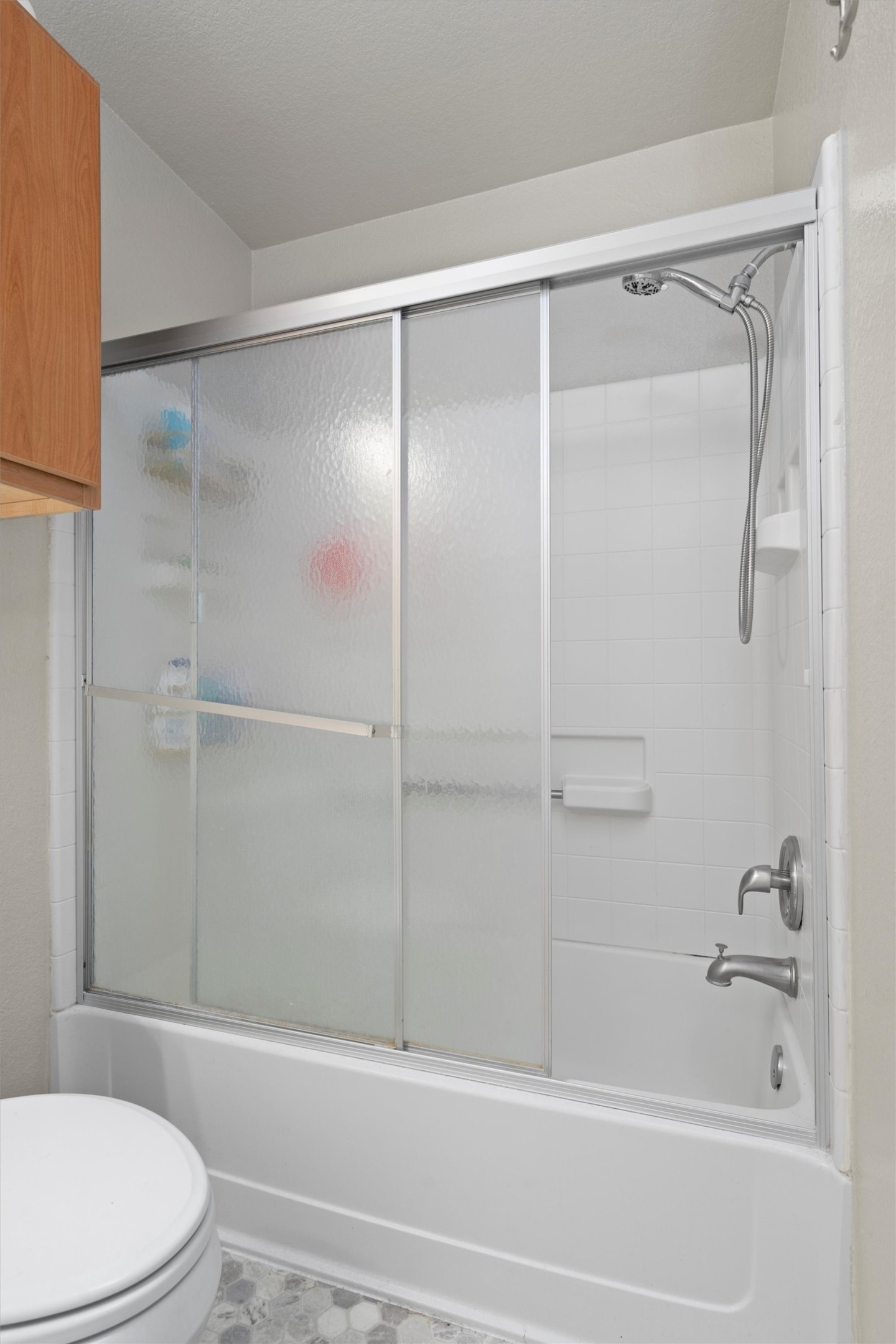 12117 Briarcreek Loop Manor, TX 78653 - Photo 20 of 29 Full bathroom featuring bath / shower combo with glass door and toilet