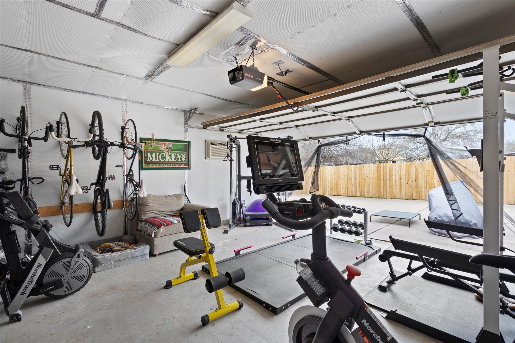 12117 Briarcreek Loop Manor, TX 78653 - Photo 27 of 29 Workout room with concrete floors, a garage, and an AC wall unit