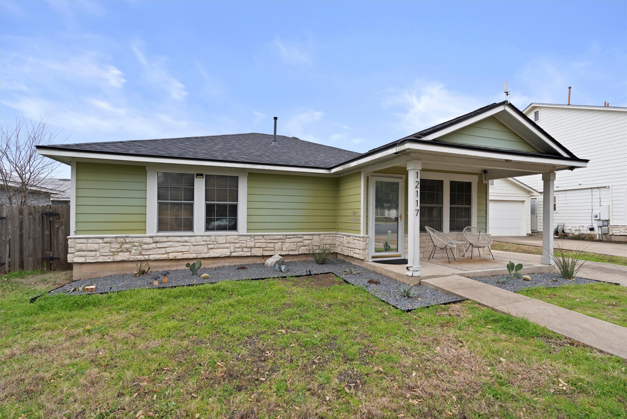 12117 Briarcreek Loop Manor, TX 78653 - Photo 28 of 29 View of front of house with stone siding, a shingled roof, and a patio