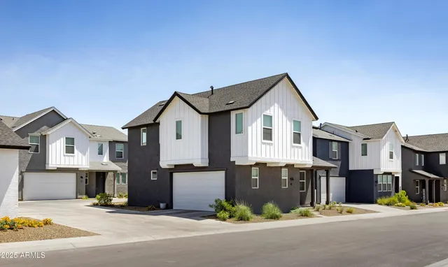 a front view of a house with a street