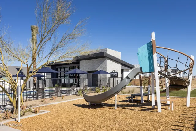 a view of a house with a big yard and a large tree