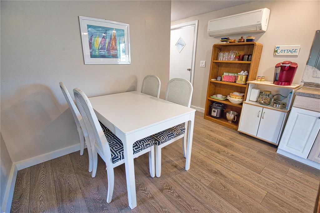 2302 Southeast Red Baron Drive Arcadia, FL 34266 - Photo 12 of 47 a view of a dining room with furniture and wooden floor