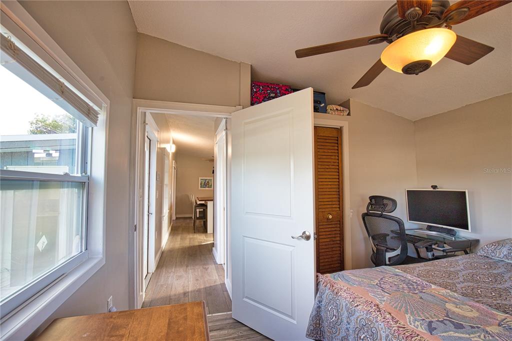 2302 Southeast Red Baron Drive Arcadia, FL 34266 - Photo 20 of 47 a bedroom with a bed and a chandelier