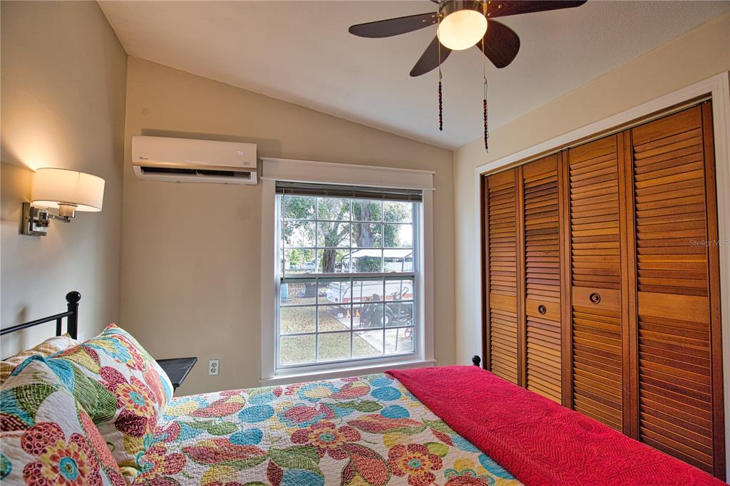 2302 Southeast Red Baron Drive Arcadia, FL 34266 - Photo 23 of 47 a bedroom with a bed and a chandelier