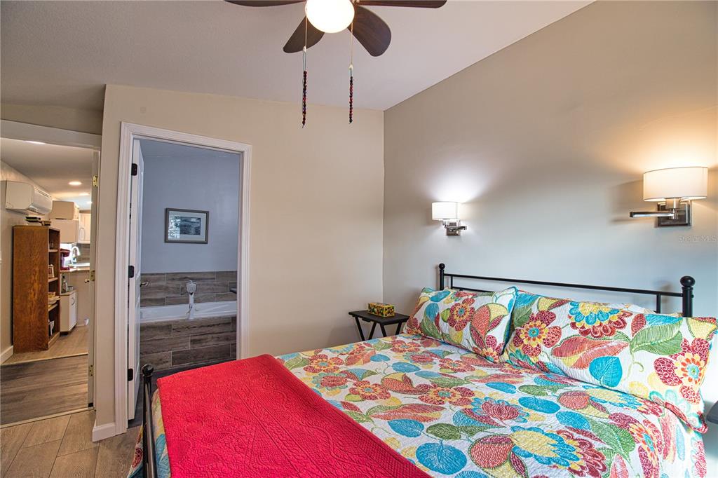 2302 Southeast Red Baron Drive Arcadia, FL 34266 - Photo 24 of 47 a bedroom with a bed and a chandelier