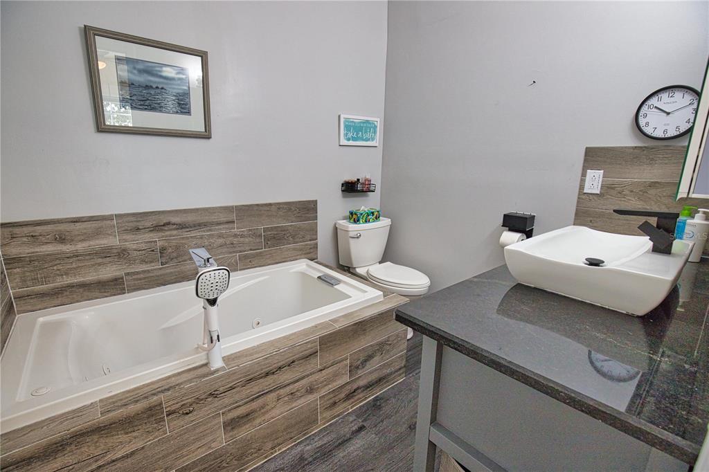 2302 Southeast Red Baron Drive Arcadia, FL 34266 - Photo 25 of 47 a bathroom with a sink and a window