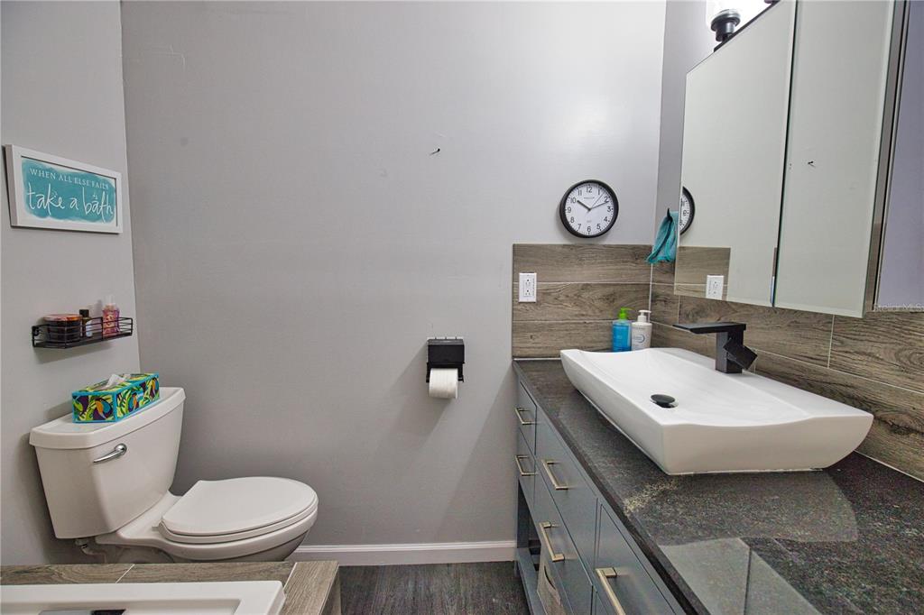 2302 Southeast Red Baron Drive Arcadia, FL 34266 - Photo 26 of 47 a bathroom with a toilet a sink and a mirror