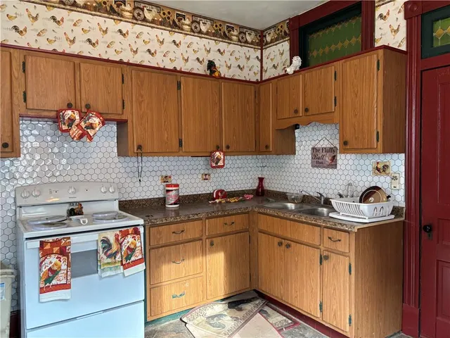 a kitchen with stainless steel appliances a stove a sink and cabinets