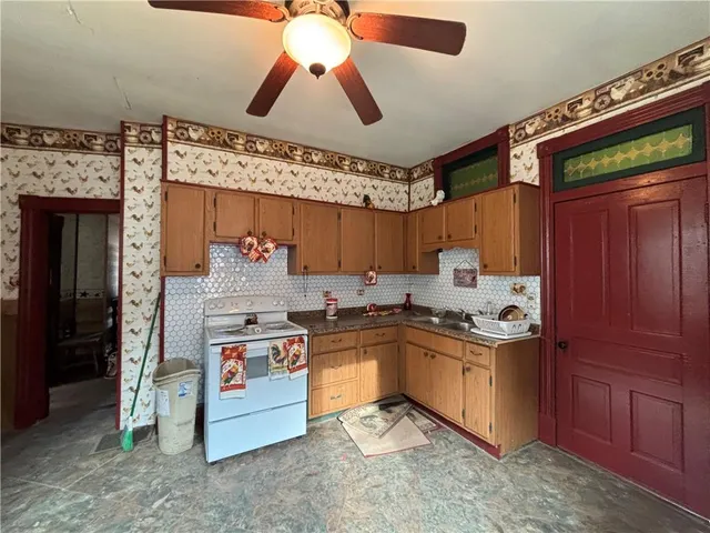 a kitchen with stainless steel appliances granite countertop a stove and a sink