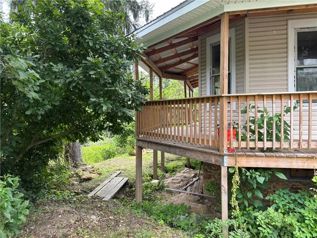 a view of a chair and table in backyard