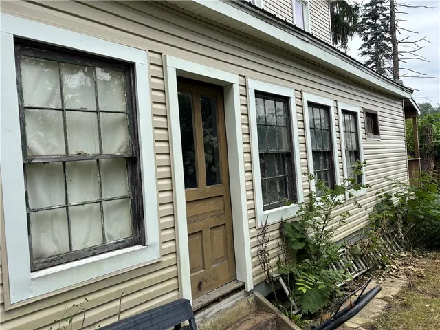 front view of a house with a potted plant