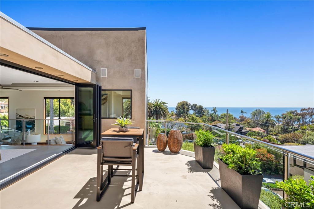 31532 Valido Road Laguna Beach, CA 92651 - Photo 11 of 31 a dining room with furniture and a floor to ceiling window