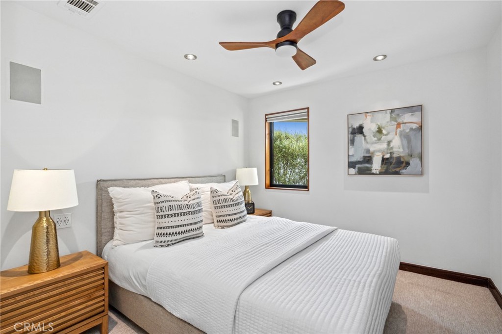 31532 Valido Road Laguna Beach, CA 92651 - Photo 28 of 31 a bedroom with a large bed and a chandelier