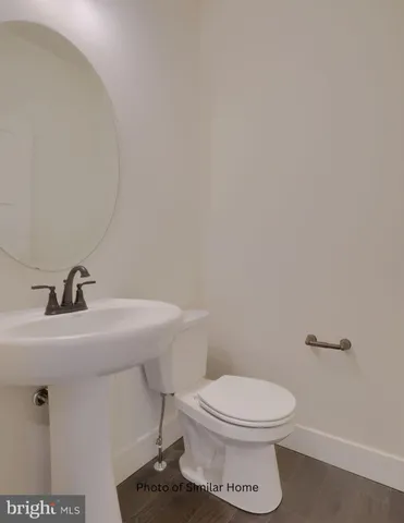 a bathroom with a toilet a sink and mirror