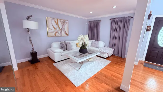 a view of living room with furniture and wooden floor