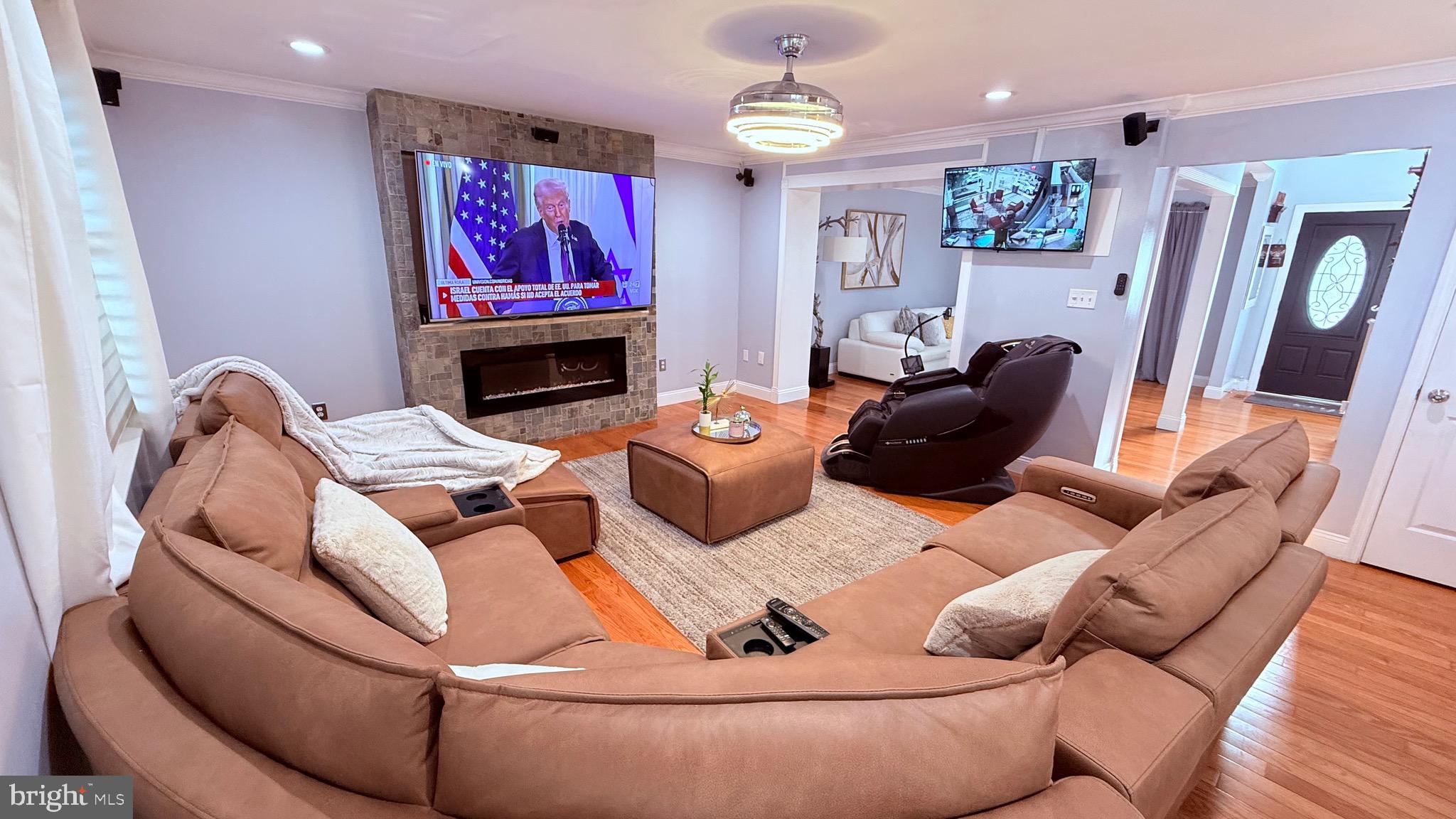 8905 Springview Road Philadelphia, PA 19115 - Photo 24 of 113 a living room with furniture a flat screen tv and a fireplace