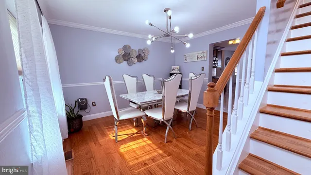 a view of a patio with table and chairs potted plants with wooden floor and fence