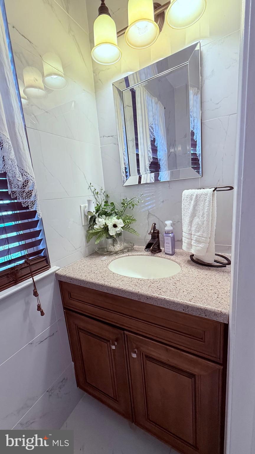 8905 Springview Road Philadelphia, PA 19115 - Photo 41 of 113 a bathroom with a sink and a mirror